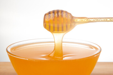 fresh fragrant honey drips from a spoon into a plate. organic vitamin nutrition. dessert food