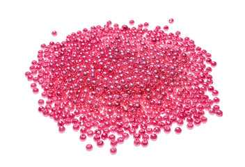 Pile of pink beads on white background