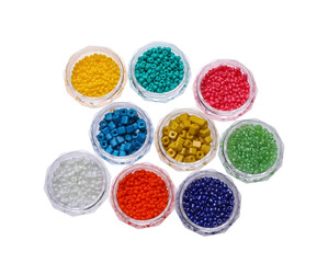 Obraz na płótnie Canvas Plastic containers with different beads on white background, top view