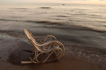 Obraz premium Rocking chair made of rattan on the beach