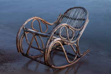 Rocking chair made of rattan on the beach