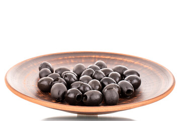 A few pickled black olives on a clay dish, macro, isolated on white.