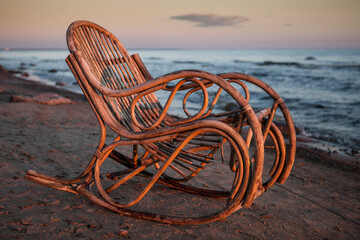 Rocking chair made of rattan on the beach