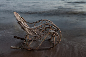 Rocking chair made of rattan on the beach