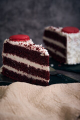 two pieces of red velvet cake with cookies on top