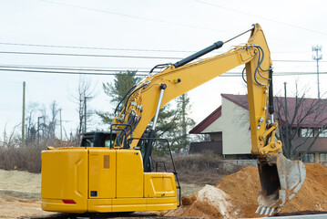 Excavator pouring ground from scoop