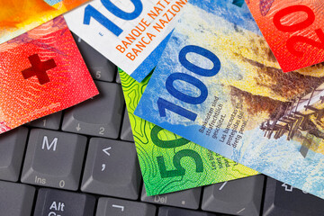 Swiss money on computer keyboard