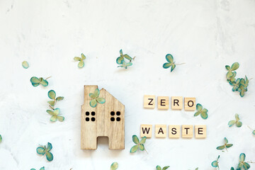 Lettering concept of zero waste and house on light background.