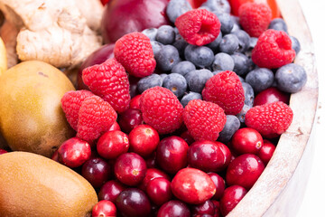 fresh vegetables and fruits isolated on a white background in wooden tray.