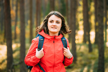Portrait Of Active Young Adult Beautiful Caucasian Girl Woman Dressed In Red Jacket Walking In Autumn Forest. Active Lifestyle In Nature. © Great Brut Here