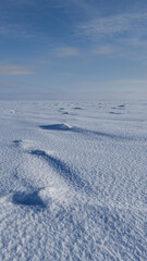 shadow lines from the snow relief and blue sky