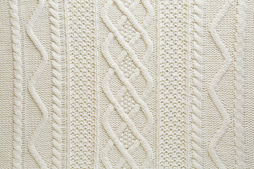 White knitted fabric with beautiful pattern as background, top view