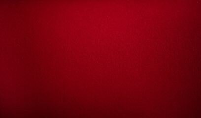 Photo of the texture of the reddish fabric. Felt of red color. Pure red background for text.