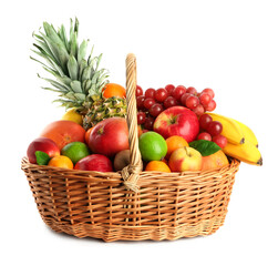 Naklejka na ściany i meble Wicker basket with different fresh fruits isolated on white