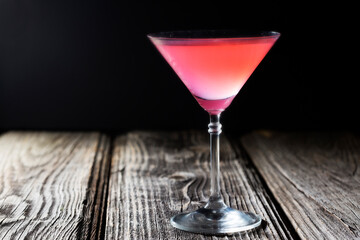 Delicious pink refreshing rose drink. Dark wooden background. cocktail 