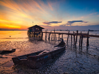 sunset on broken fishing boat