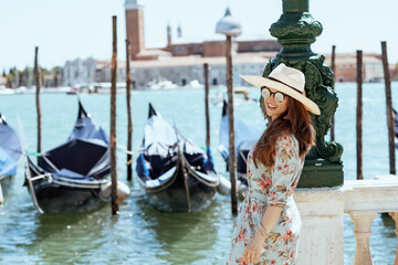 happy traveller woman in floral dress enjoying promenade