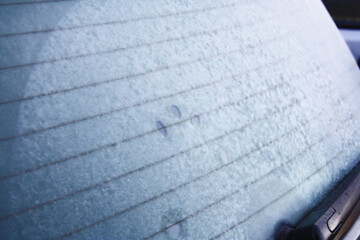 Fototapeta premium Frozen Back window of car. Ice crystals on glass. Rear view. 
