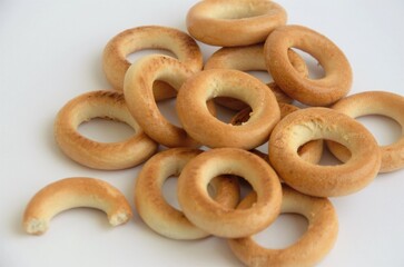 round bagels on a white background in a heap, minimalism