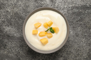 Delicious yogurt with fresh peach and mint on grey table, top view