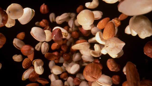 Super Slow Motion Closeup Shot of Falling Various Nuts Towards Camera on Black at 1000fps.
