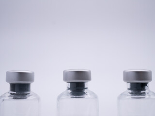 Close up of three bottles of liquid medicine  - 482717524