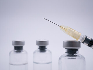 Vaccine bottles and syringe close with white background - 482717533