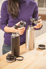 Woman changing lid of water bottles