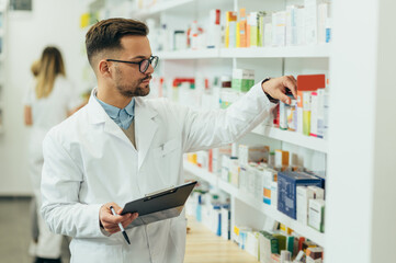 Portrait of a handsome pharmacist working in a pharmacy