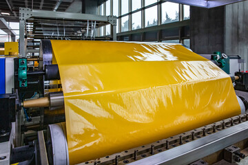 Tape production factory. Laminating and rewinding kind of protective film machine with clamping...