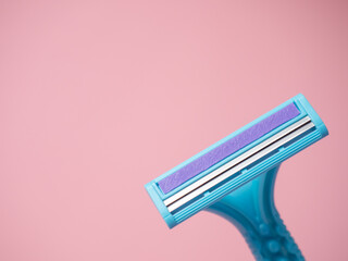 women's blue shaving machine on a pink background