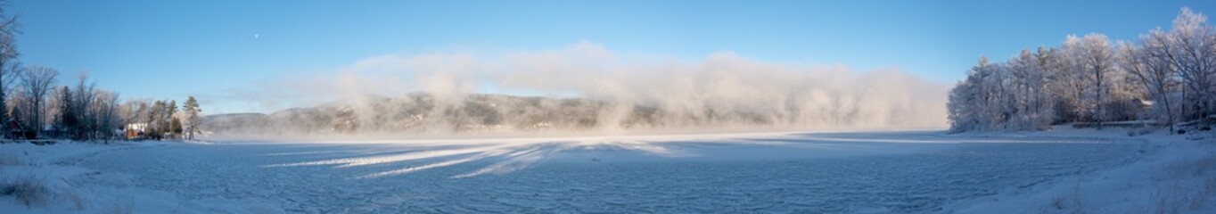 Panoramic view of a winter scene with a lake and ice steam view of a winter scene with a lake and ice steam