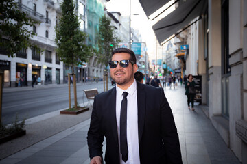 groomed latin man walks around the city