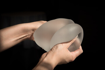 Silicone implant of the female breast during the demonstration of its quality.
