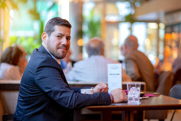 latino entrepreneur looking at camera in a coffee shop