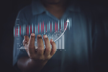 Traders or businessman are showing virtual hologram stocks growing on hand, business growth, progress or success idea concept, strategy planning, stock market, digital assets.