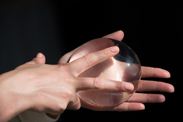 Silicone implant of the female breast during the demonstration of its quality.