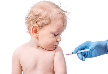 A small child got an injection in the his shoulder. Vaccination of a little boy, isolated on white background.