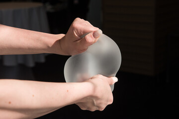 Silicone implant of the female breast during the demonstration of its quality.