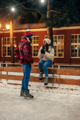 Biracial couple having date at outdoors rink