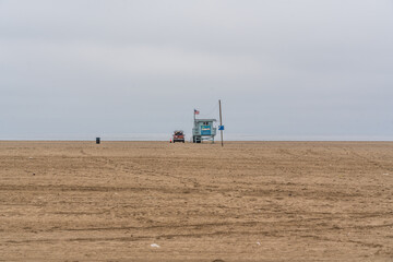 empty beach at Venice Beach, Los Angeles, California - far away on the horizon the lifeguard tower 