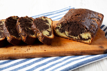 Homemade Chocolate and Vanilla Marble Cake on a rustic wooden board, side view. Close-up.