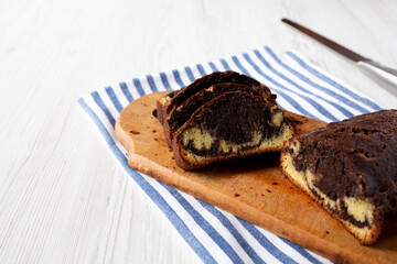 Homemade Chocolate and Vanilla Marble Cake on a rustic wooden board, side view. Copy space.