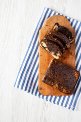 Homemade Chocolate and Vanilla Marble Cake on a rustic wooden board, top view. Copy space.