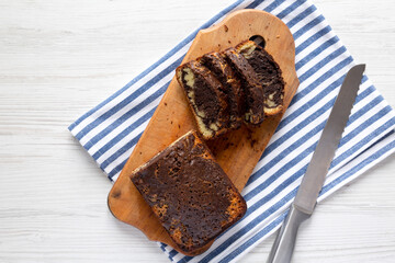 Homemade Chocolate and Vanilla Marble Cake on a rustic wooden board, top view. Flat lay, overhead, from above. Copy space.
