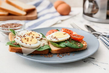 Plate with tasty toasts on table