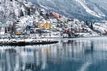 Odda, Norway - January 08 2022: City Odda and Hardangerfjord in Norway during winter with snow