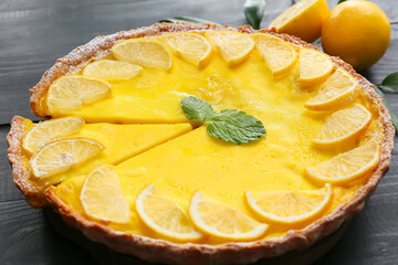 Tasty lemon tart on dark wooden background