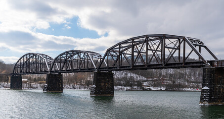 A metal train bridge over the Allegheny River in Aspinwall, Pennsylvania, USA on an overcast winter day