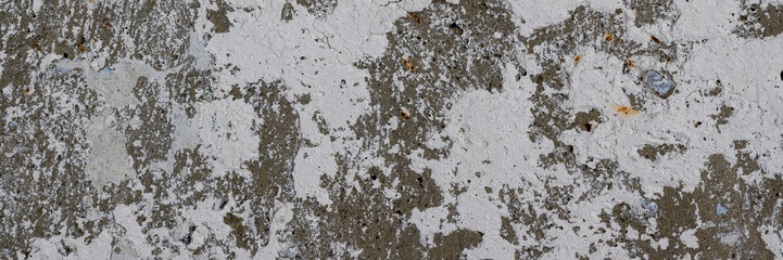 Old wall with cracked stucco. Weathered rough surface. Wide panoramic texture for background and design.